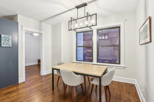 dining room with dark wood-type flooring and baseboards