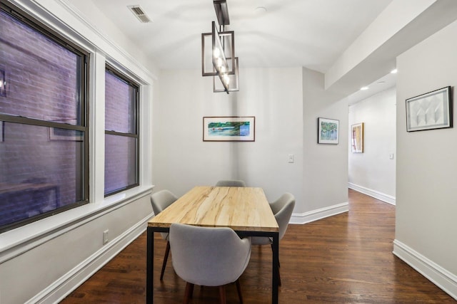 dining area with baseboards, visible vents, wood finished floors, a notable chandelier, and recessed lighting