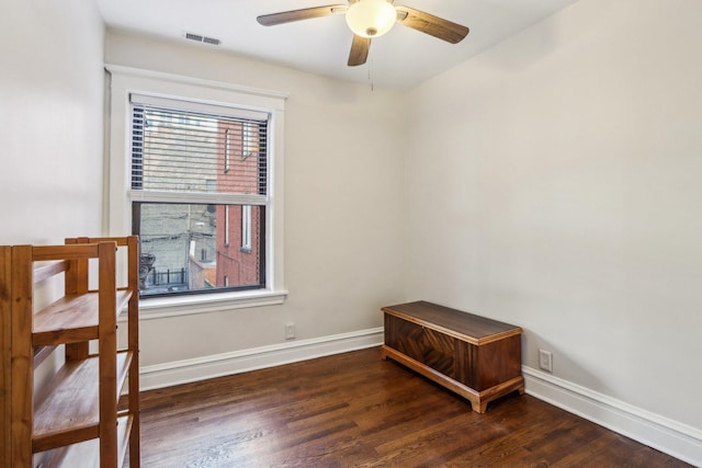 unfurnished room with ceiling fan, wood finished floors, visible vents, and baseboards