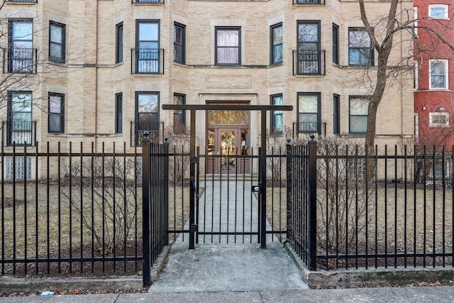 view of gate with a fenced front yard