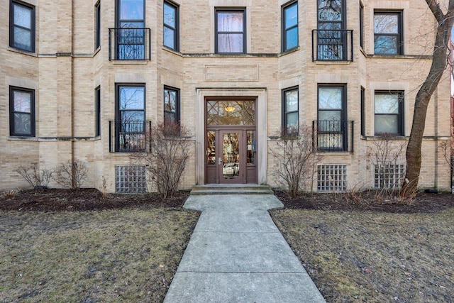 property entrance featuring brick siding