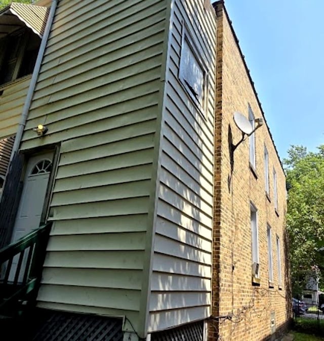 view of side of home featuring brick siding and a chimney