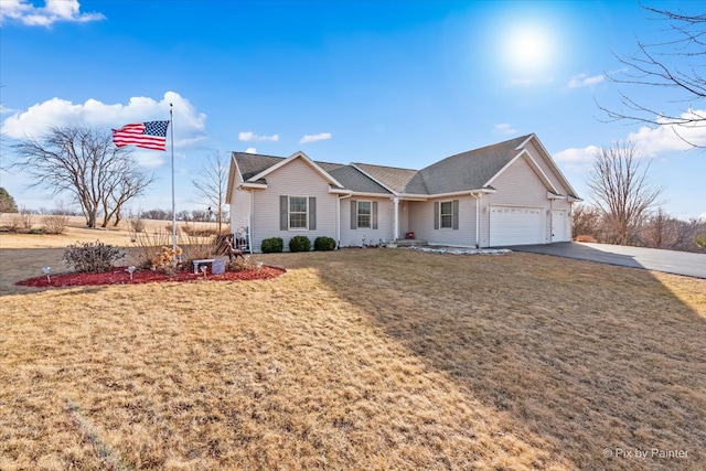 ranch-style home with a garage, a front yard, and aphalt driveway