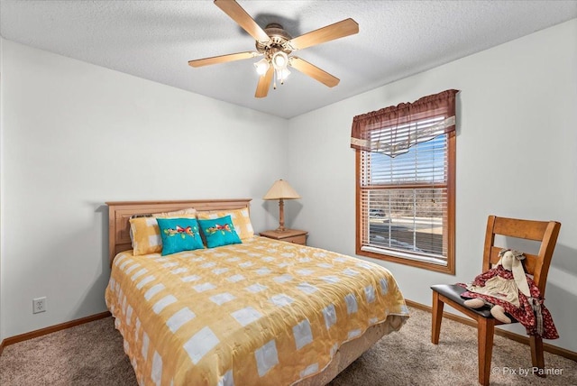 bedroom with a textured ceiling, carpet, a ceiling fan, and baseboards