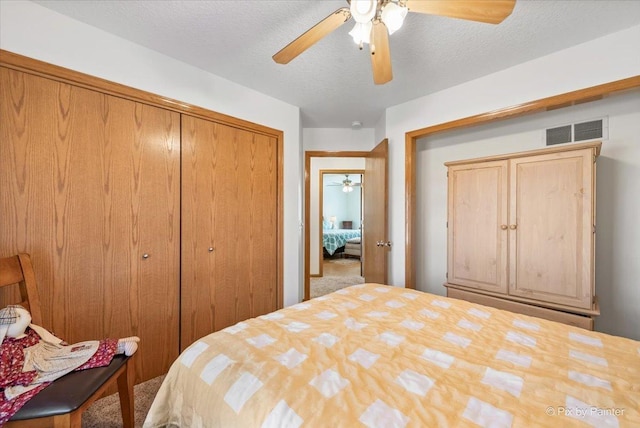 bedroom featuring a textured ceiling, a closet, visible vents, and a ceiling fan