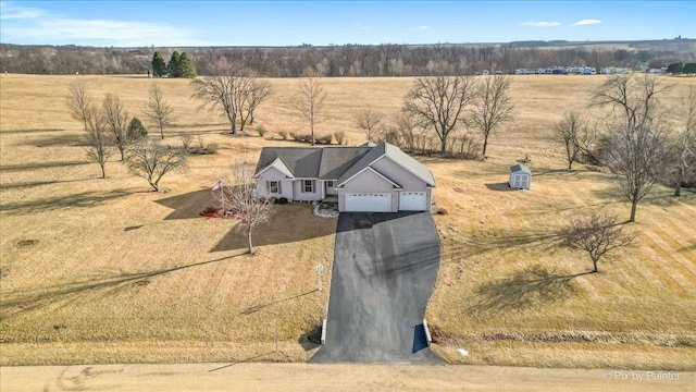 birds eye view of property with a rural view