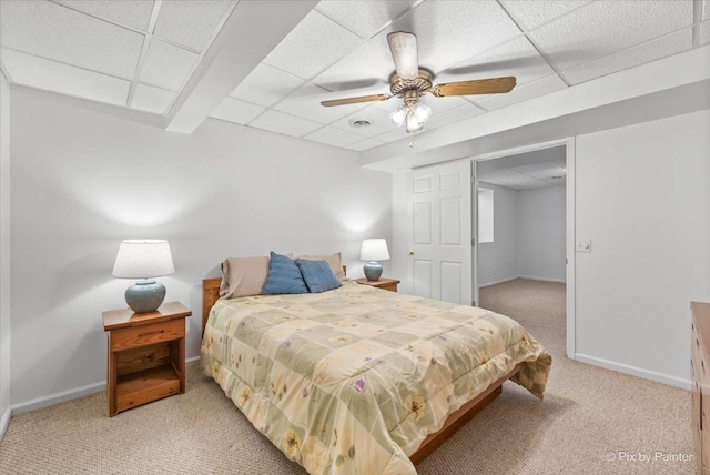 bedroom featuring a paneled ceiling, carpet flooring, and baseboards