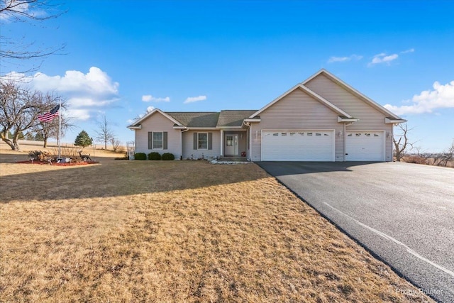 single story home featuring a garage, a front yard, and driveway