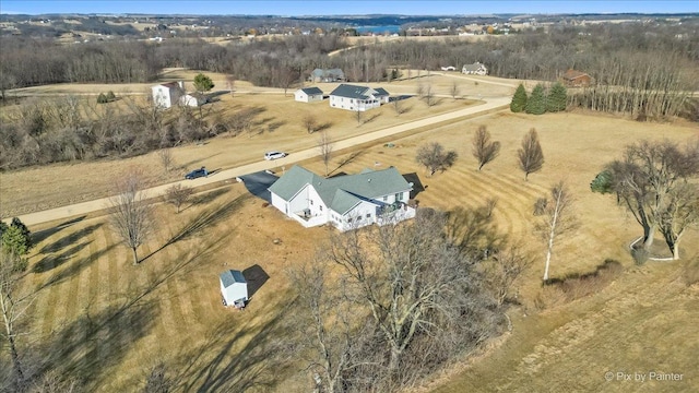 birds eye view of property with a rural view