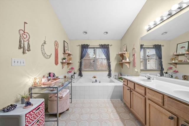 bathroom with a bath, double vanity, a sink, and tile patterned floors