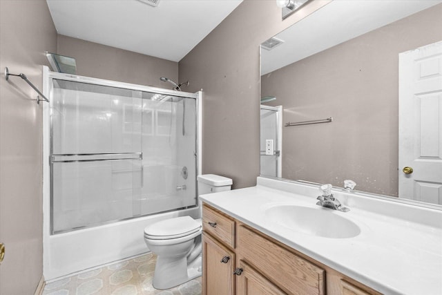 bathroom featuring toilet, enclosed tub / shower combo, visible vents, and vanity