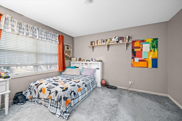 carpeted bedroom featuring baseboards