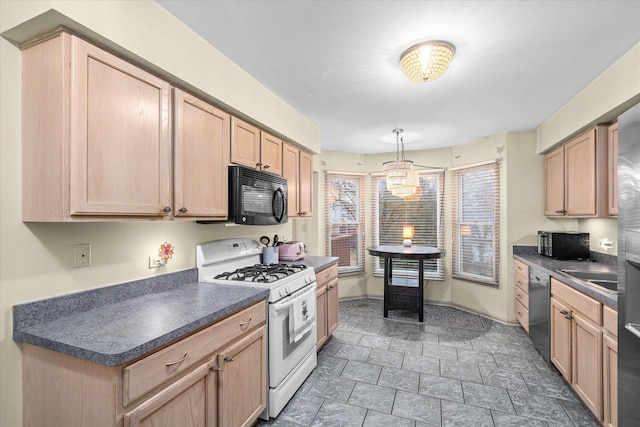 kitchen with black microwave, white gas range, and dark countertops