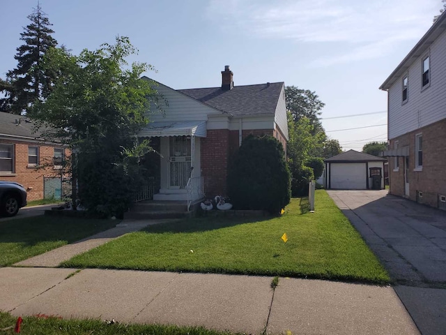 bungalow-style house featuring a chimney, a front yard, a garage, driveway, and an outdoor structure