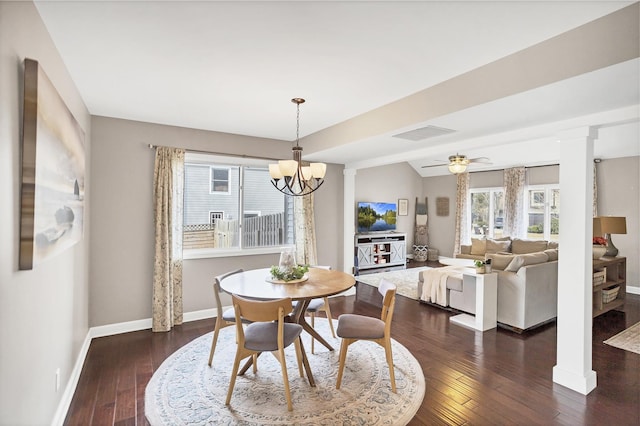 dining space featuring decorative columns, visible vents, baseboards, dark wood finished floors, and ceiling fan with notable chandelier