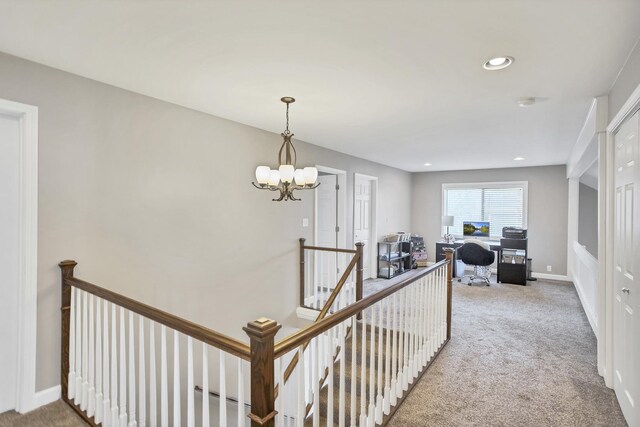 corridor with carpet, a notable chandelier, recessed lighting, an upstairs landing, and baseboards