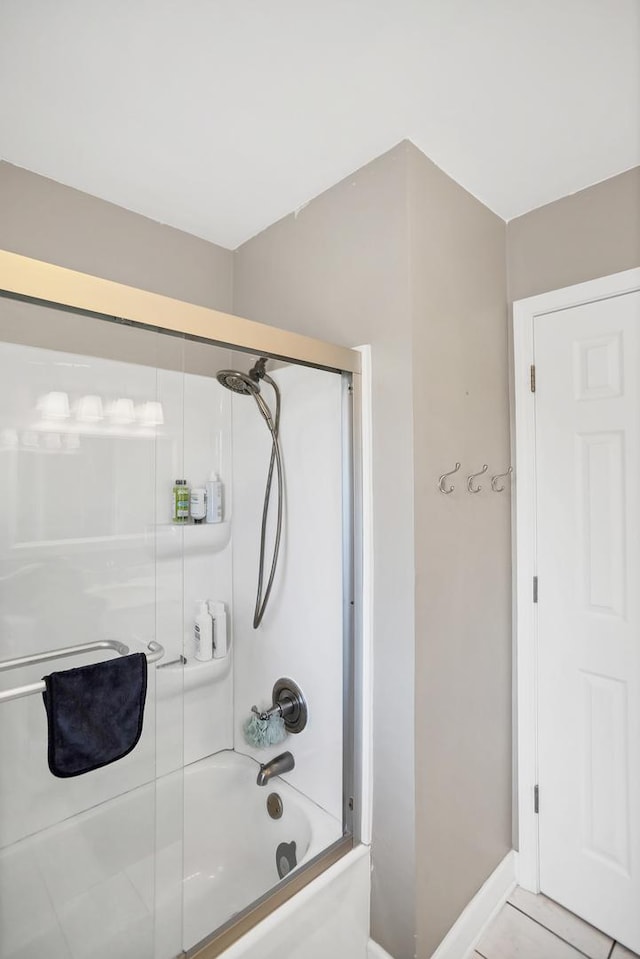 full bathroom with tile patterned flooring, combined bath / shower with glass door, and baseboards