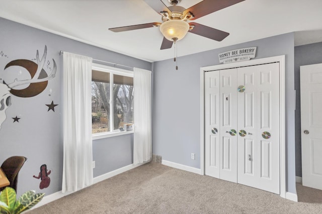 bedroom with a ceiling fan, a closet, baseboards, and carpet flooring