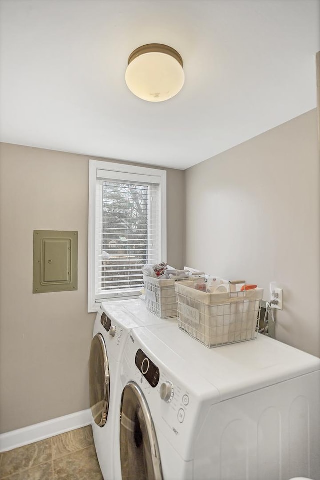 laundry area featuring laundry area, electric panel, independent washer and dryer, and baseboards