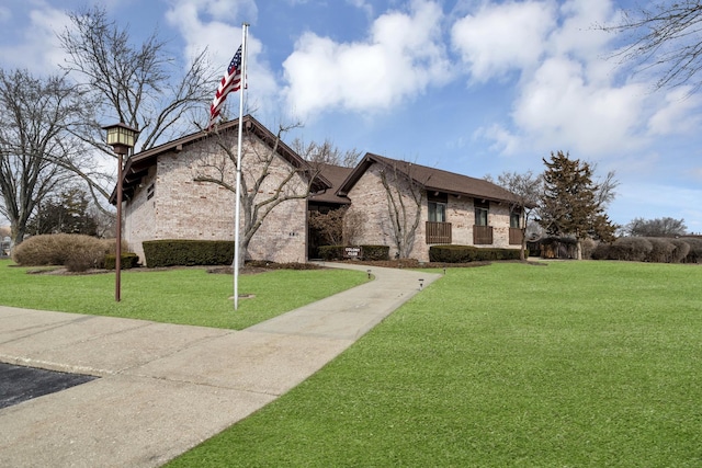 french country inspired facade with a front lawn and brick siding