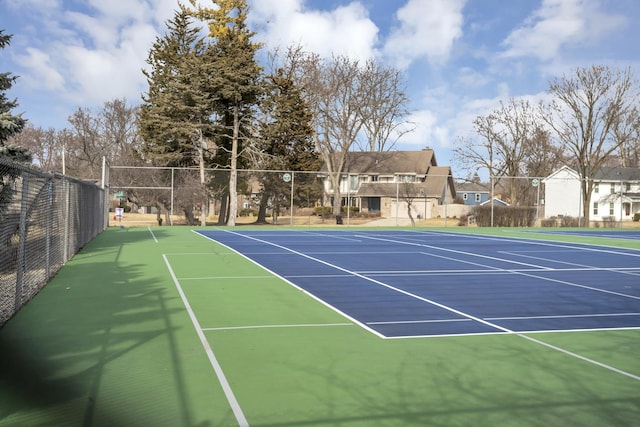 view of tennis court featuring fence