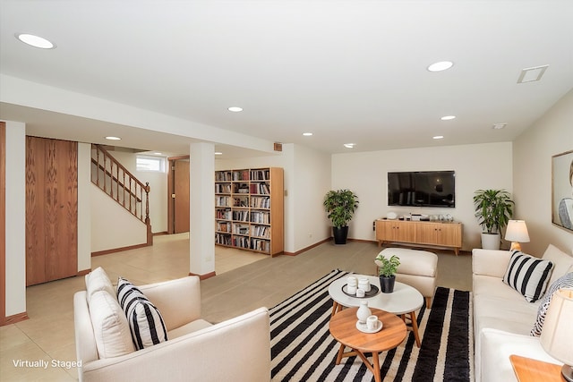 living room featuring stairs, light tile patterned flooring, baseboards, and recessed lighting