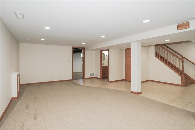 finished below grade area featuring recessed lighting, baseboards, and light colored carpet