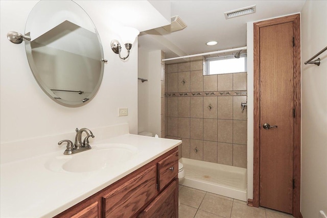 bathroom featuring a stall shower, visible vents, toilet, tile patterned flooring, and vanity