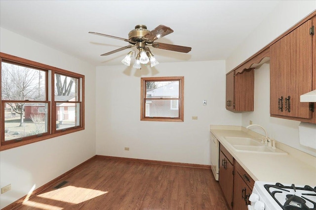 kitchen with wood finished floors, a sink, visible vents, light countertops, and dishwasher