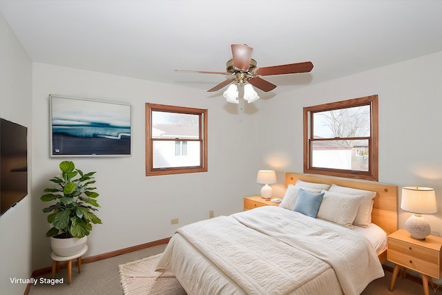 bedroom with carpet floors, multiple windows, baseboards, and a ceiling fan