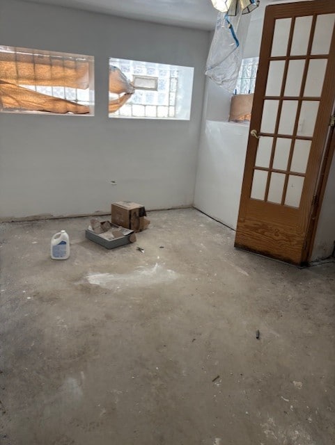 unfurnished room with concrete floors