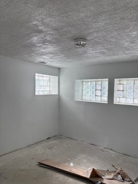 spare room with a textured ceiling