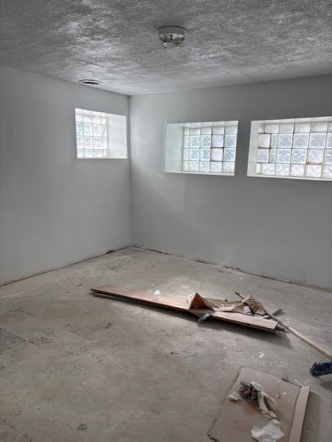 unfurnished room featuring a textured ceiling