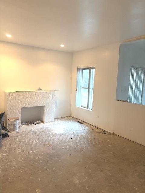1519 E 68th St Unit 1, Chicago, IL 60637 - unfurnished living room featuring recessed lighting and a fireplace with flush hearth