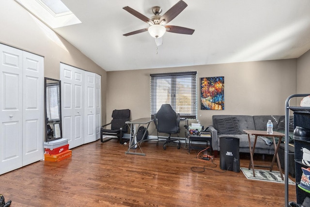 office featuring a ceiling fan, vaulted ceiling with skylight, and wood finished floors