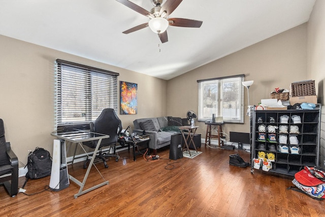 office featuring lofted ceiling, ceiling fan, baseboards, and wood finished floors