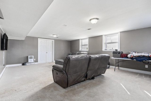 carpeted cinema room with baseboards, visible vents, and heating unit