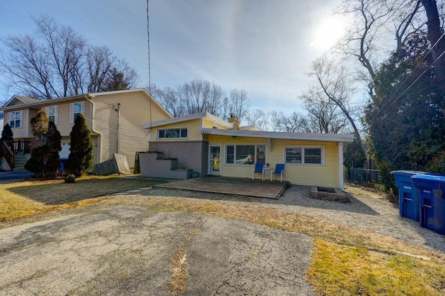 view of front of property featuring a deck and a chimney