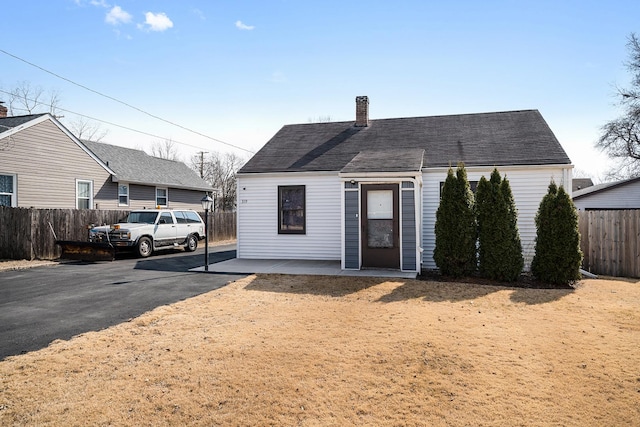 view of front of house with fence and a chimney