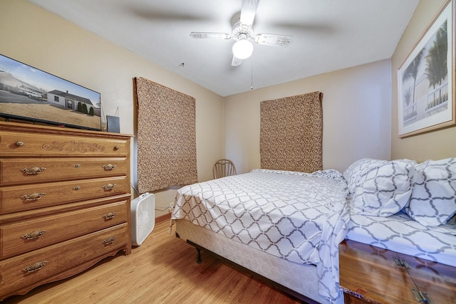 bedroom featuring light wood-type flooring and a ceiling fan