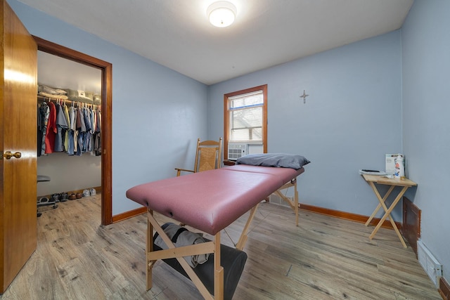 playroom with light wood-style flooring, visible vents, and baseboards