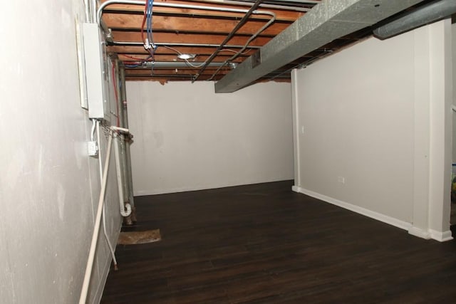 unfinished basement with baseboards and wood finished floors