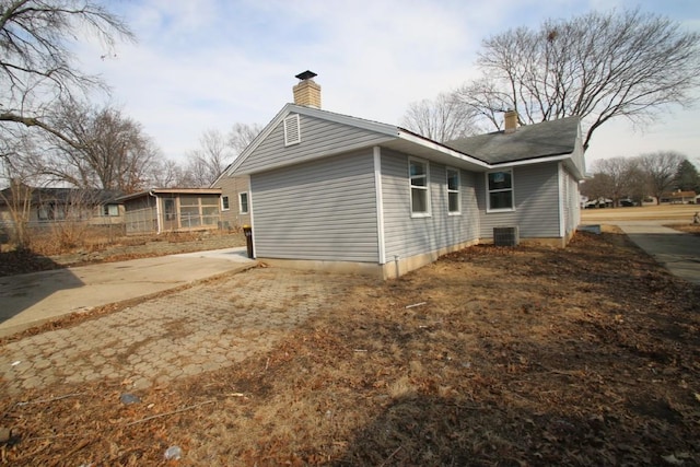 view of property exterior with a chimney