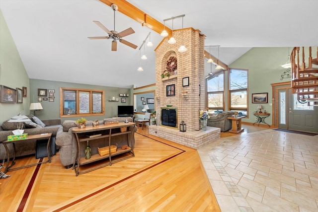 living area with a fireplace, a ceiling fan, wood finished floors, high vaulted ceiling, and beamed ceiling