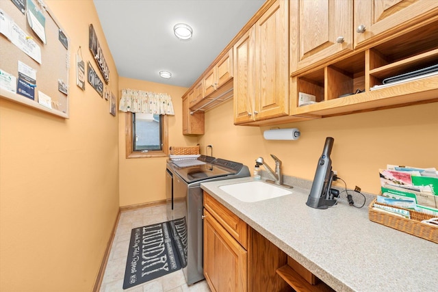 laundry area featuring cabinet space, washing machine and dryer, light tile patterned flooring, a sink, and baseboards