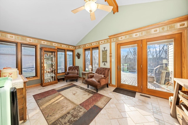 sunroom featuring visible vents, ceiling fan, and lofted ceiling with beams