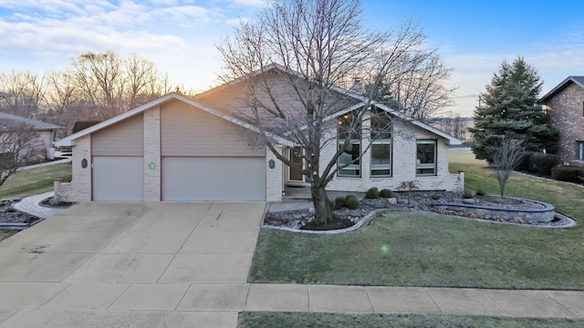 mid-century inspired home featuring concrete driveway, a front lawn, an attached garage, and brick siding