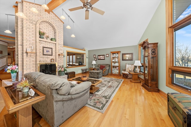 living area featuring high vaulted ceiling, wood finished floors, and a wealth of natural light