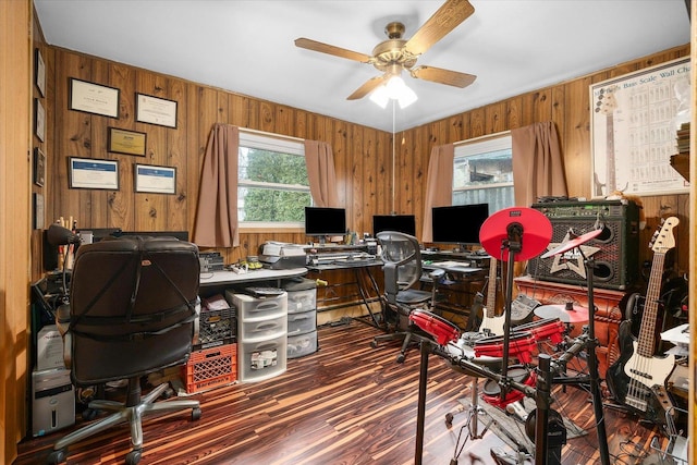 home office featuring ceiling fan, wood walls, and wood finished floors