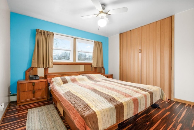 bedroom with baseboards, ceiling fan, and baseboard heating